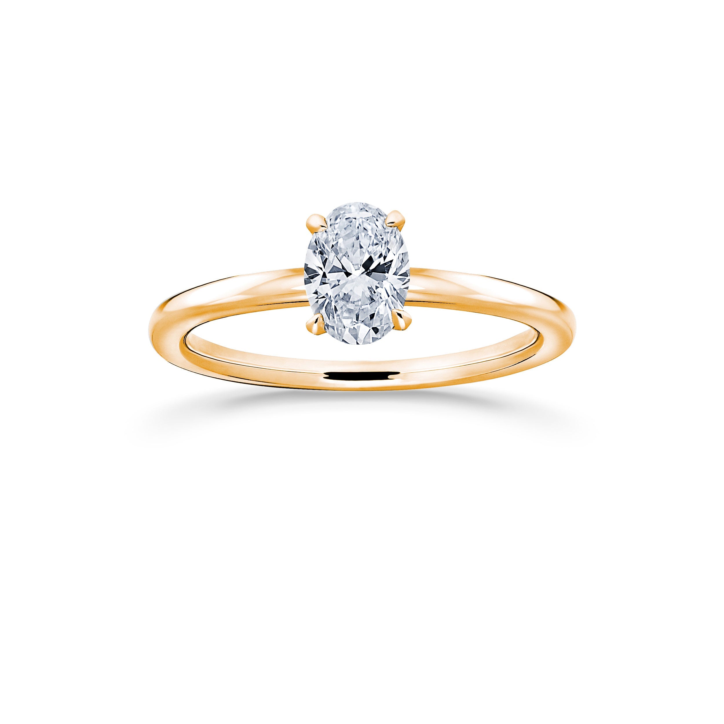 An oval diamond ring with a yellow gold band, the center diamond is colourless and sparkly, displayed against a white background.